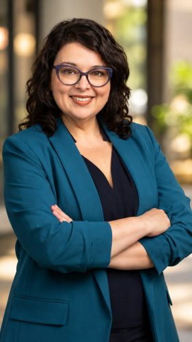 Woman wearing a teal blazer in a professional portrait